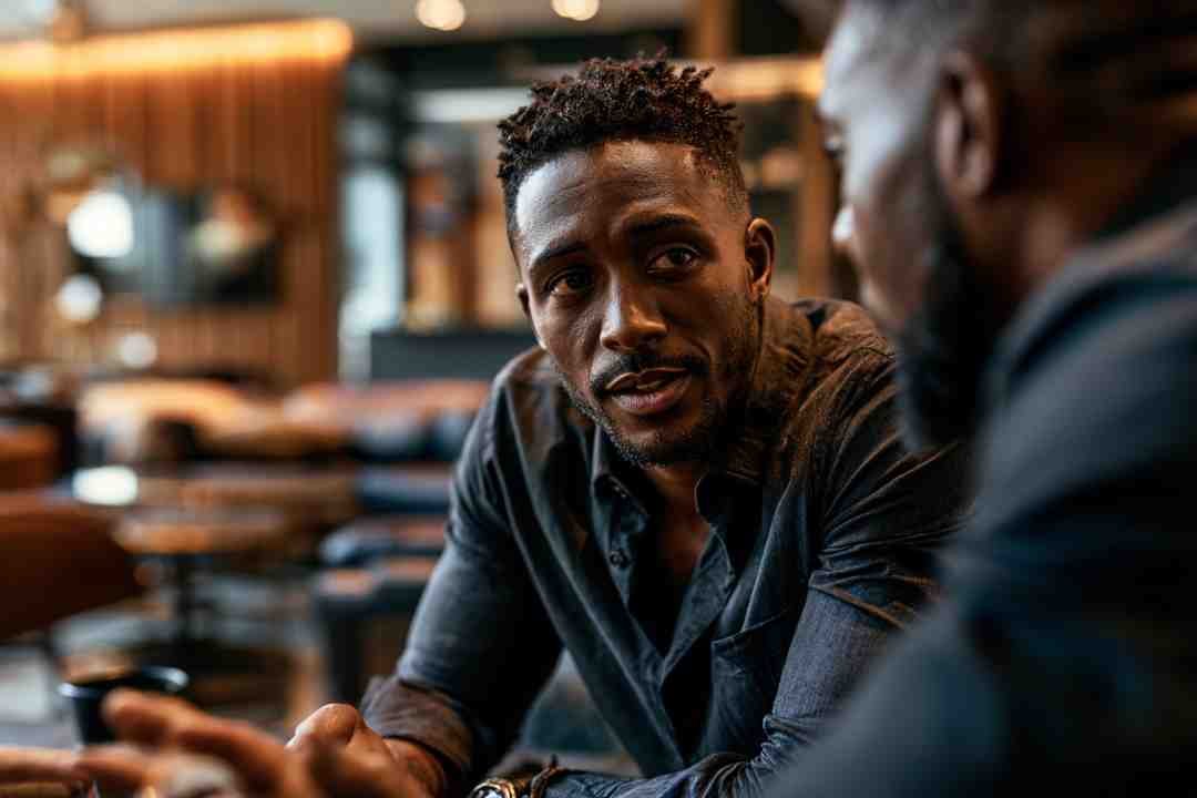 Two men in an intent, close conversation