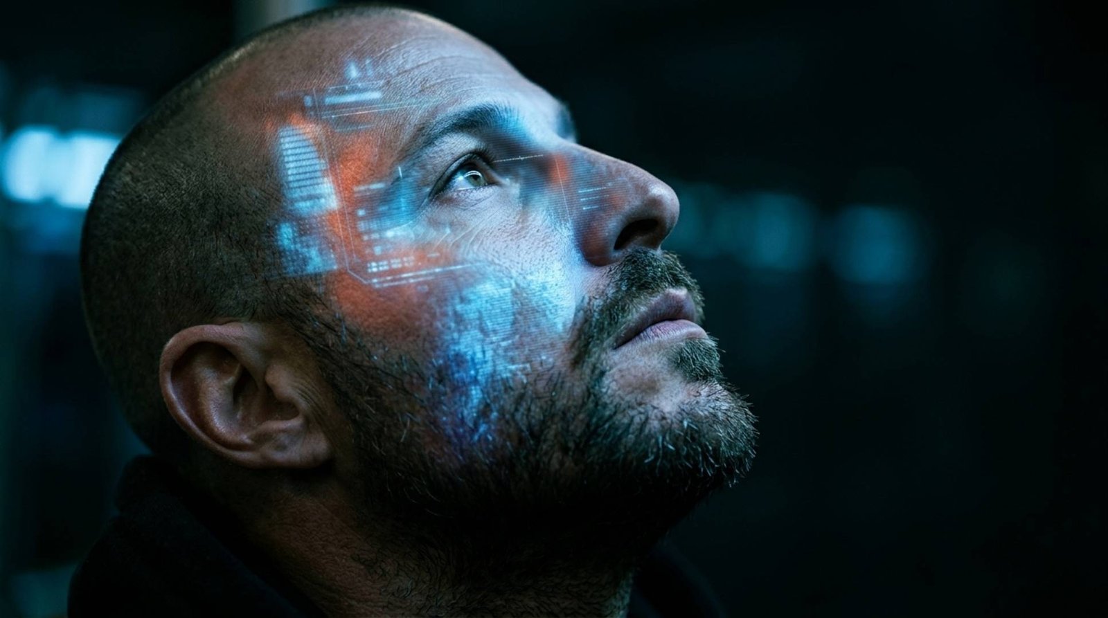Close-up portrait of a man looking upward, with a faint holographic data overlay across his face